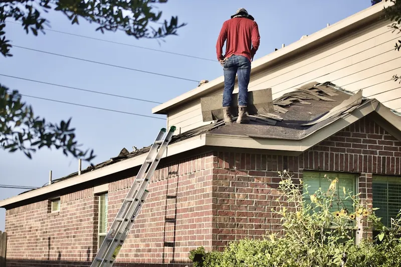 Professional roofer working on a residential roof in Edie